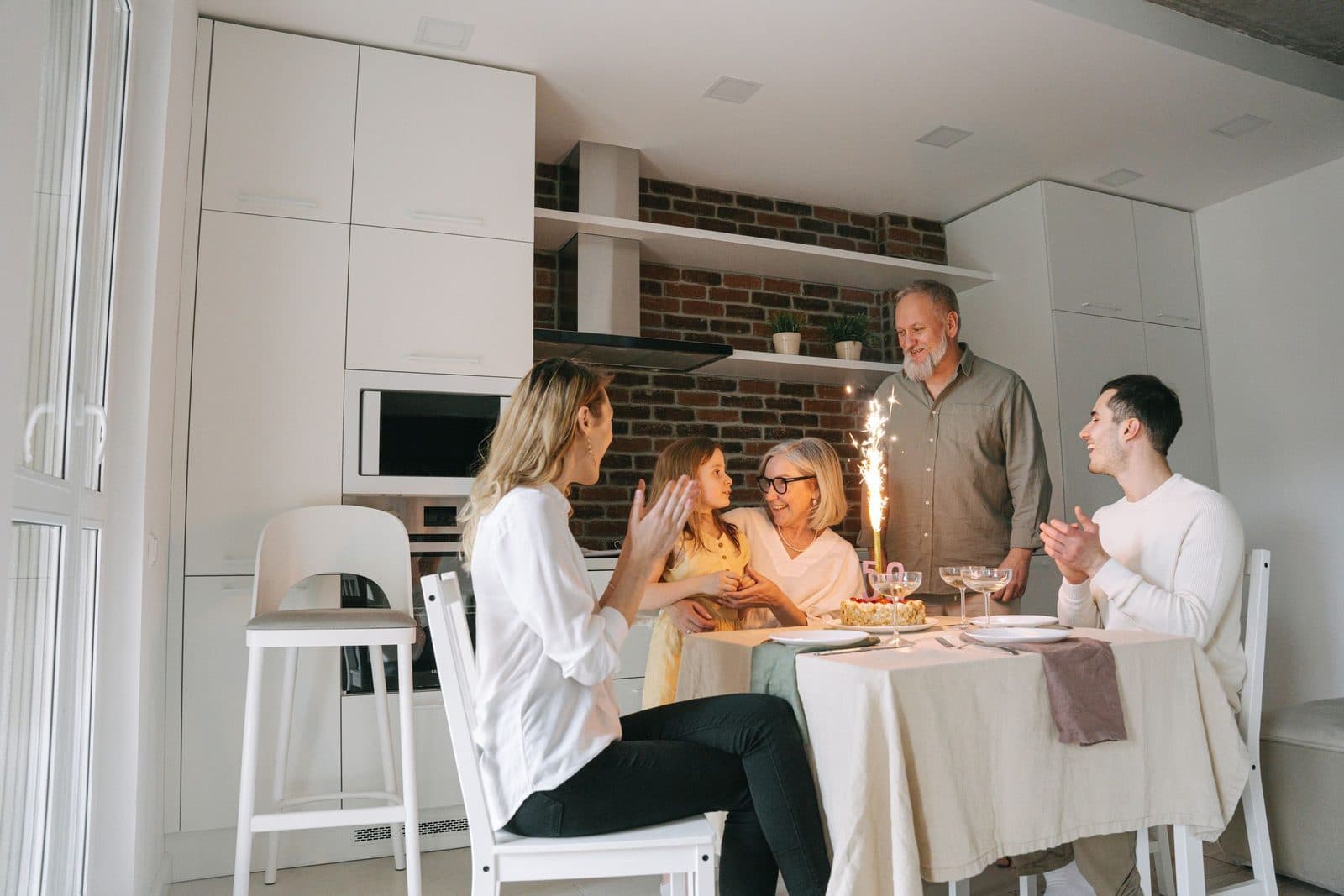 A family of three generations sharing a meal around the table at home