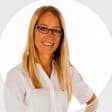 NiQui Chatfield, in glasses and a white top, against a white background